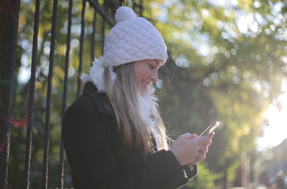 A person checking their phone outdoors